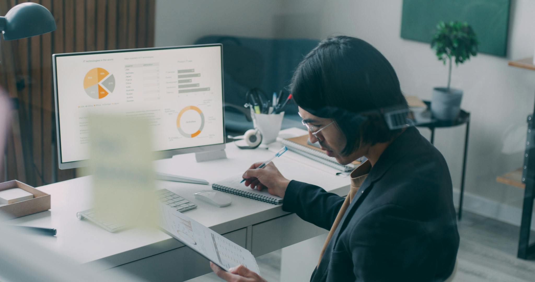 Business person reviewing analytics and charts at a modern office desk