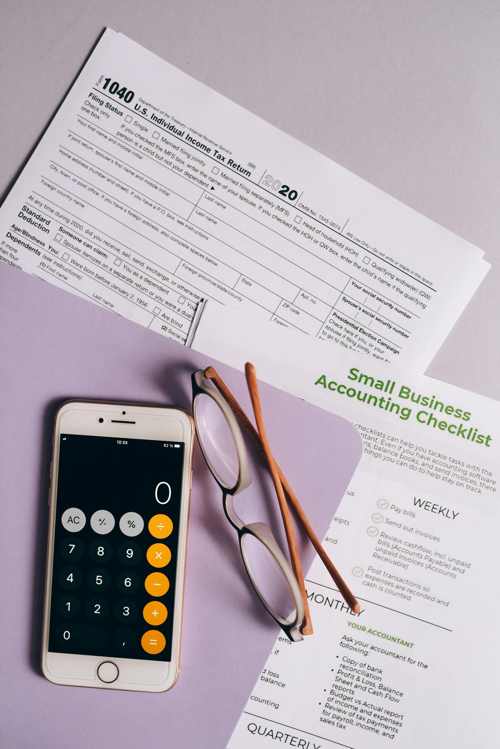 Resources 4 flat lay of tax forms checklist smartphone and glasses for small business accounting. 8962453 scaled 1